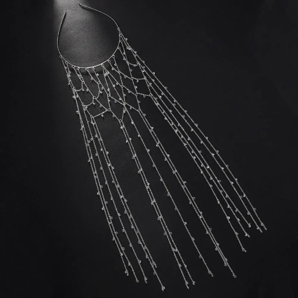 Close-up of a gold rhinestone mesh headband for women with a dangling tassel decoration.
