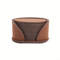 10 round felt coasters in black, brown, dark gray, and light gray arranged on a dining table
