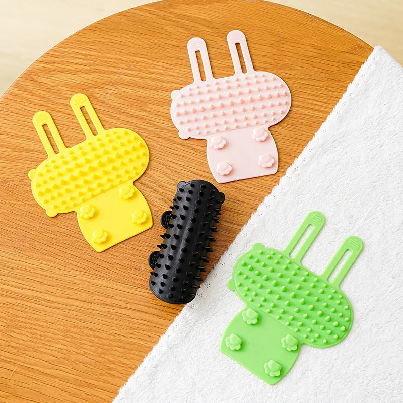 Silicone cat grooming and scratching comb with adjustable strap in black, green, pink, or yellow.
