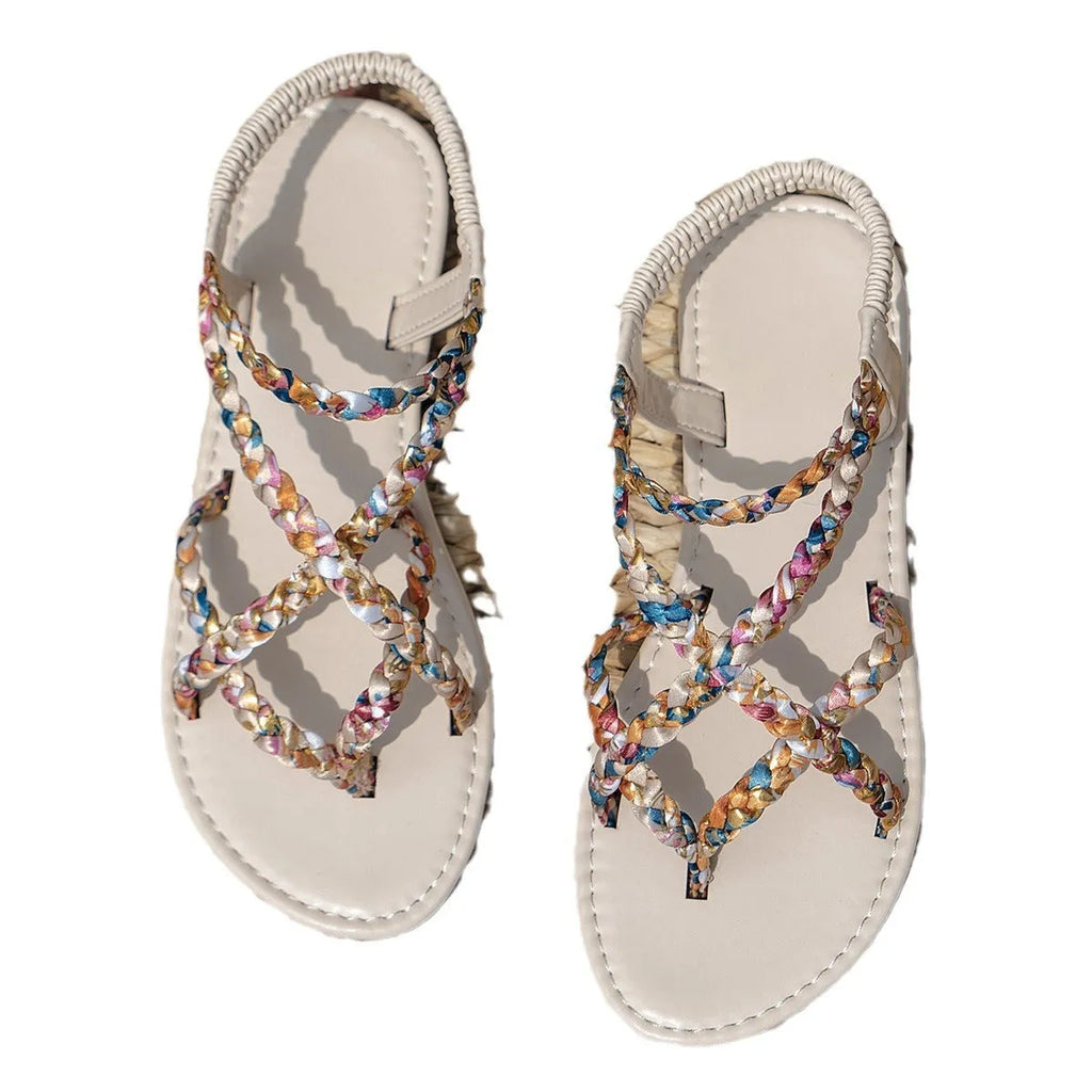 Adult flat sandals with elastic band, round toe, and cloth upper in black and white colours.