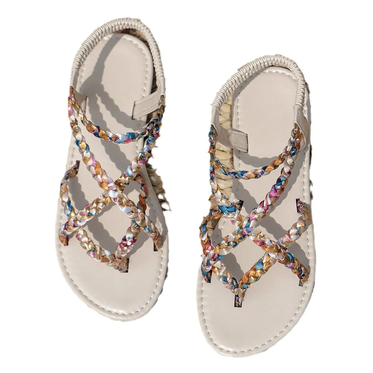 Adult flat sandals with elastic band, round toe, and cloth upper in black and white colours.