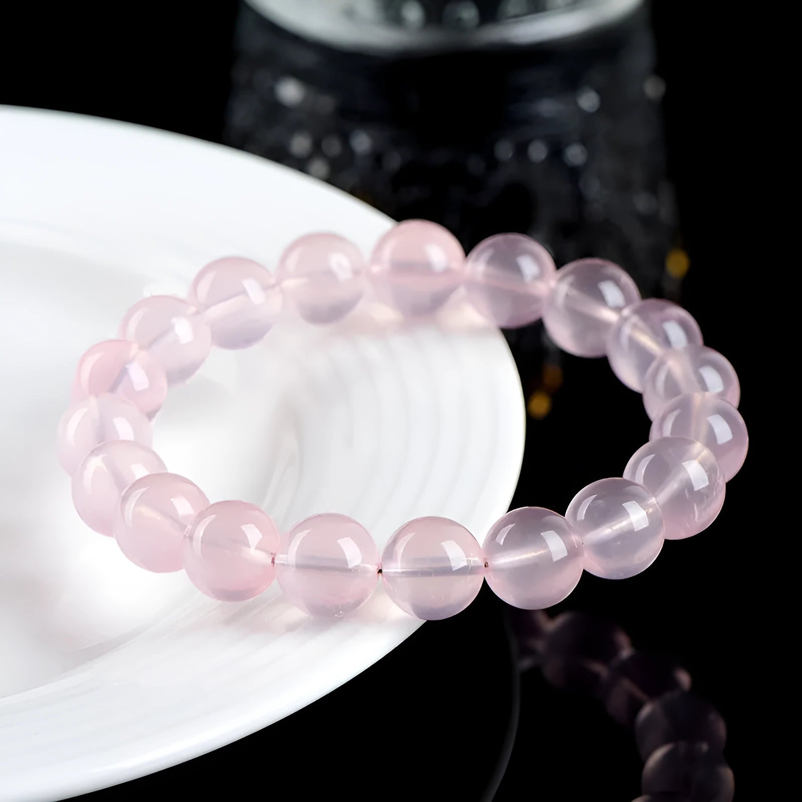 Natural pink starlight crystal round bead bracelet with polished 10mm stones on elastic cord