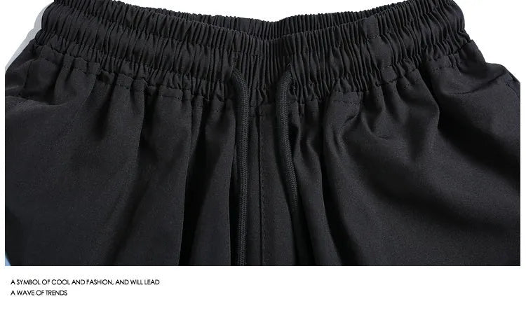 Black quick-drying sports shorts with elastic waistband and loose straight-leg design