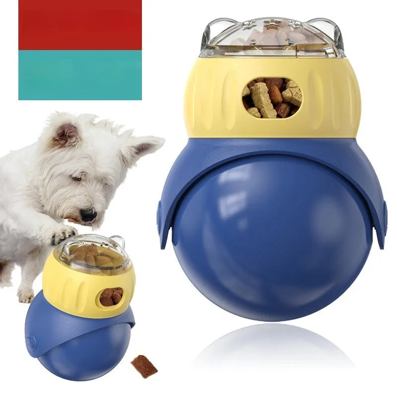 Yellow and blue plastic tumbler owl cat puzzle feeder toy on a wooden floor.