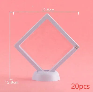 3D floating display case holding a coin suspended between transparent membrane sheets, black frame