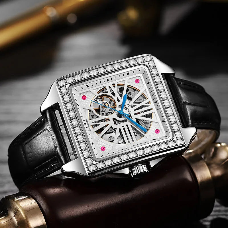 Men's square automatic watch with diamond studs on a black leather strap.
