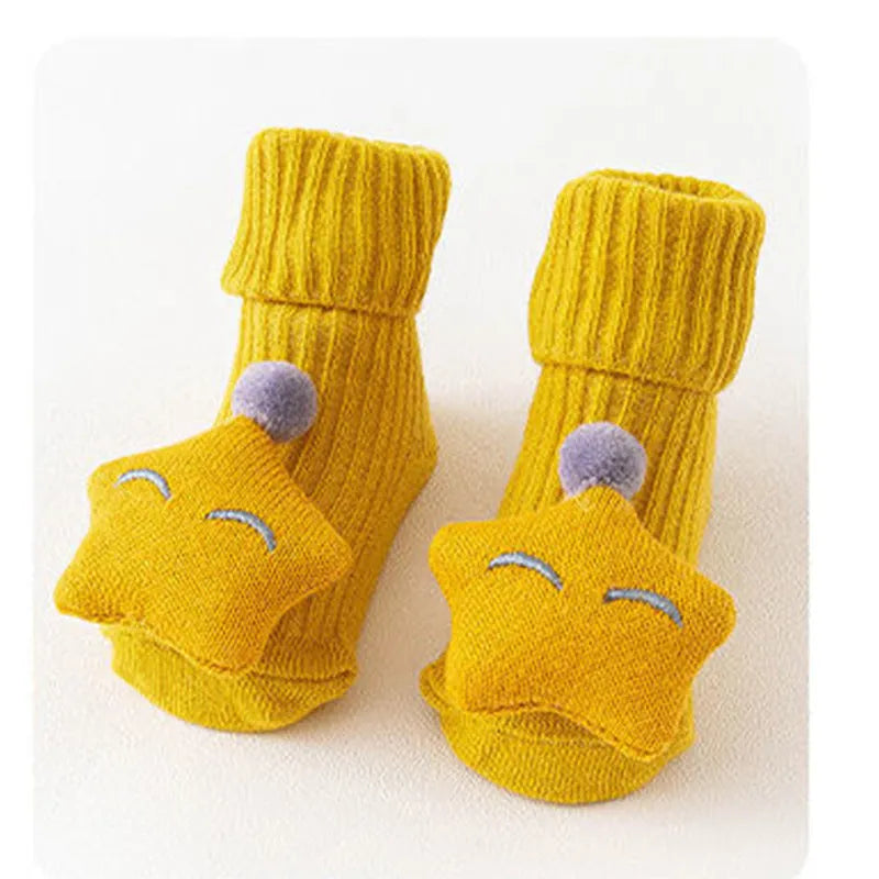 Cotton baby floor socks in various colours and patterns including pink bows, grey stars, and panda design.