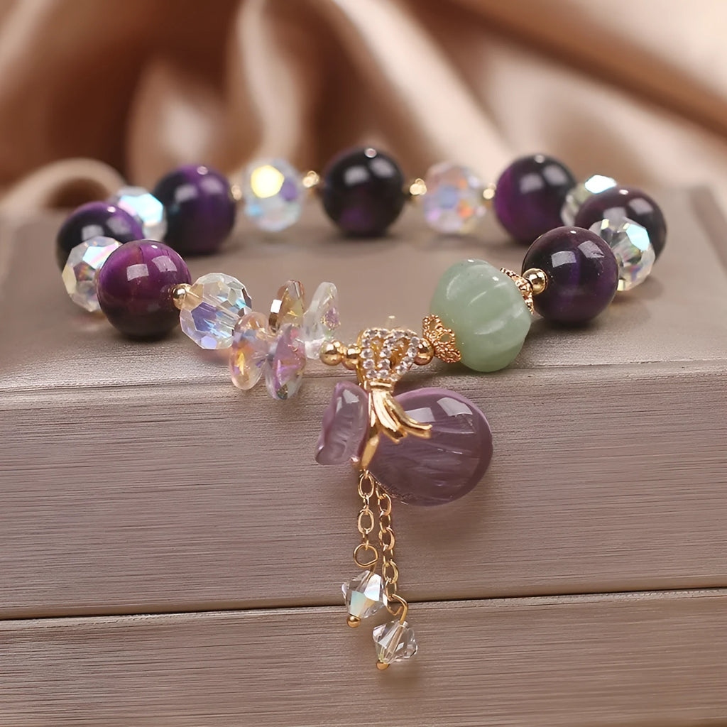 Women's forest style bracelet with purple tiger eye money bag pendant and rhinestone crystal details