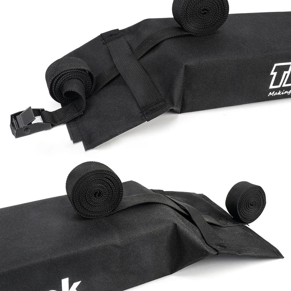 Black folding soft roof rack on a car roof, made of 600D Oxford cloth, with webbing straps and metal buckles