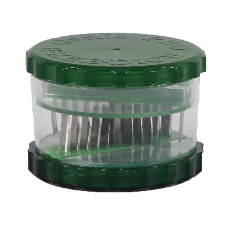 Green transparent PP plastic garlic peeler, 8.5 x 8.5 x 6 cm, on kitchen surface