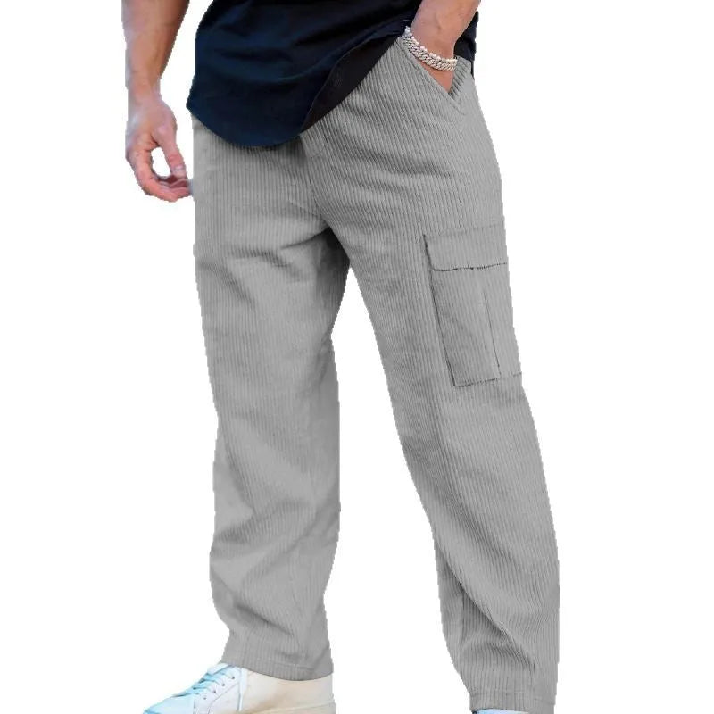Men's navy blue corduroy cargo trousers with a drawstring waist and wide straight legs laid flat.