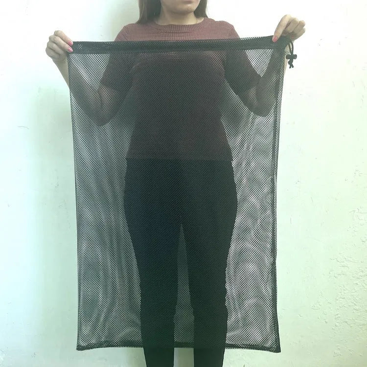 Black drawstring mesh storage bag for children's water ball toys, shown open with a toy inside.
