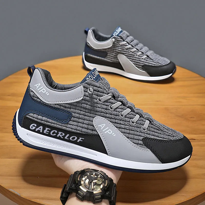 Men's green and grey running shoes with mesh upper and lace-up closure on neutral background