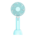 Blue handheld portable mini fan with USB cable, three-speed buttons, and shaking head design on desktop