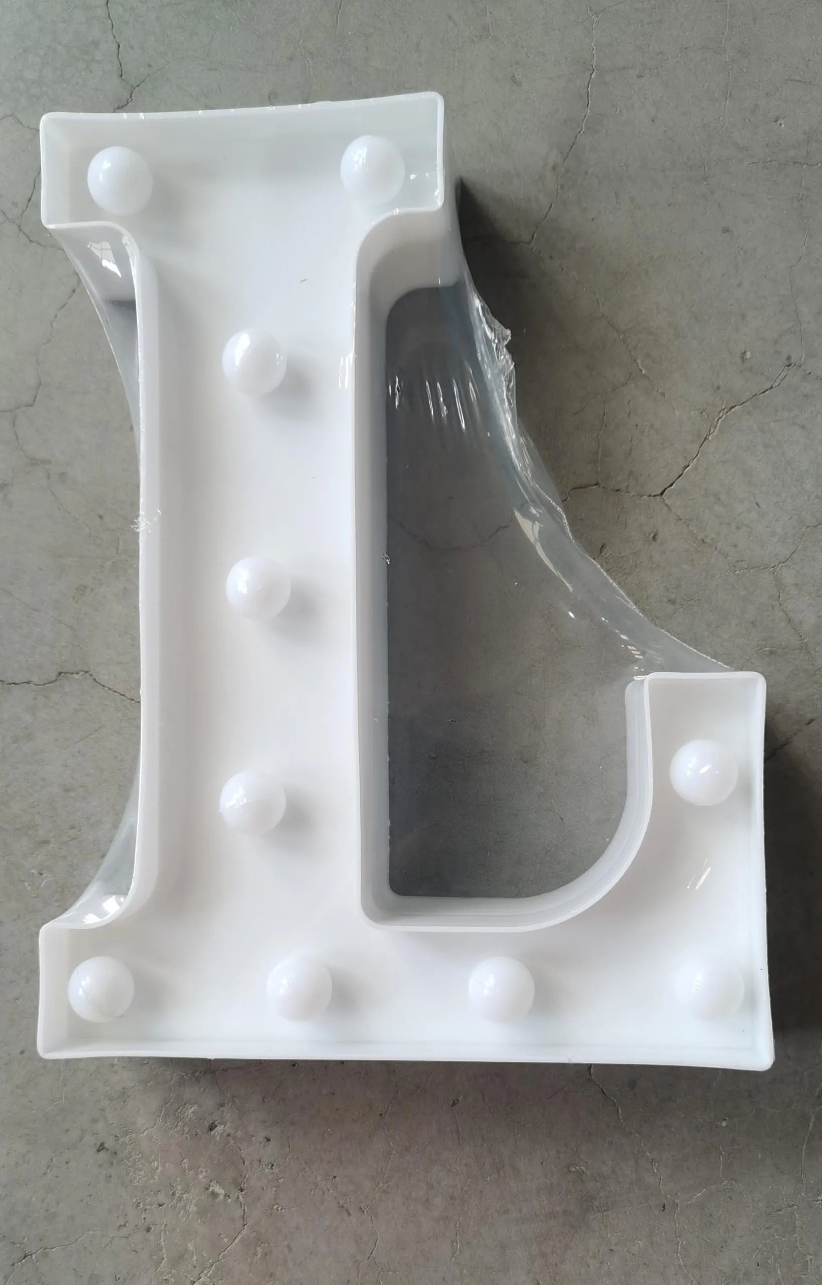 White plastic LED marquee letter sign with warm white glow, 22cm tall