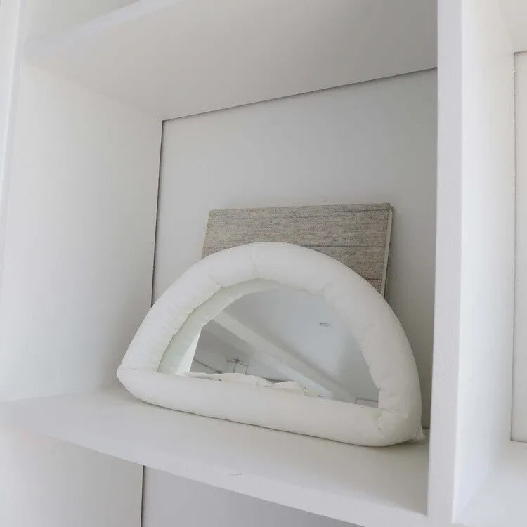 Soft rectangular fabric mirror panel in sapphire blue with a padded texture, shown hanging.