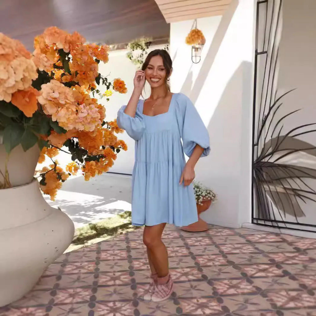 Light blue square collar puff sleeve backless A-line dress for a girl on a hanger.