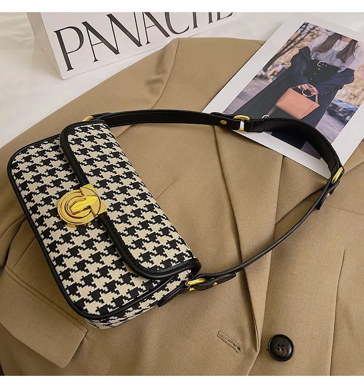 Women's houndstooth canvas baguette shoulder bag with adjustable strap on model