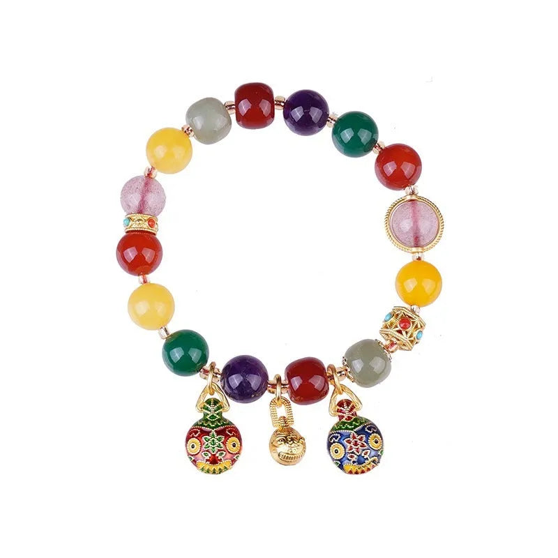 Hand-woven agate bracelet with 10mm swallowing gold beast beads on display