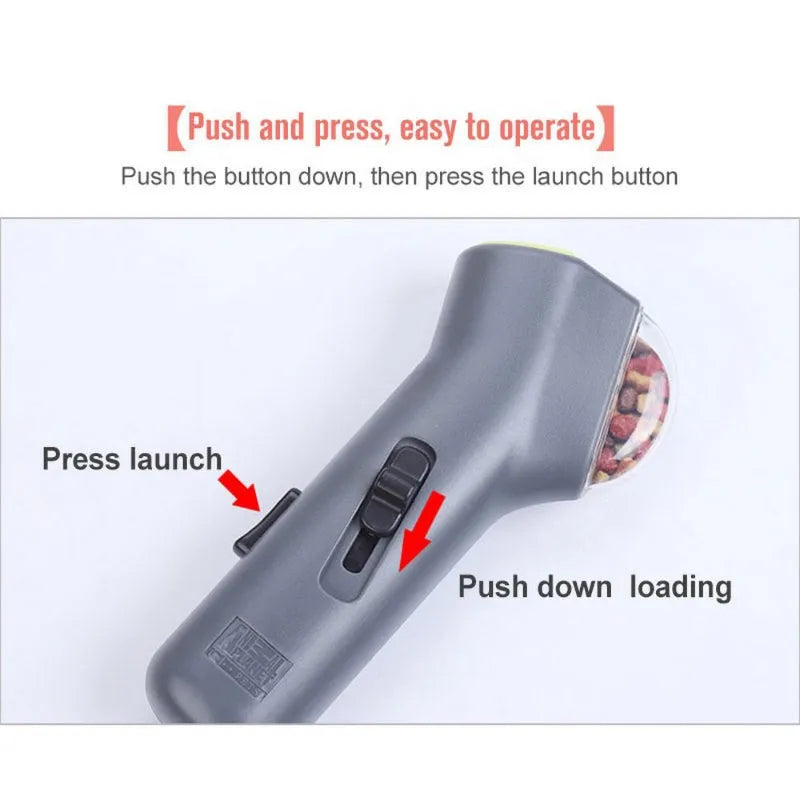 Grey pet snack catapult launcher for dog and cat training, showing handle and treat compartment