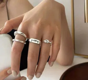 Korean-style 925 sterling silver minimalist ring for women with adjustable opening on a plain background