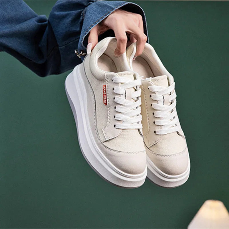 Women's beige leather board shoes with a thick platform sole on a white background.
