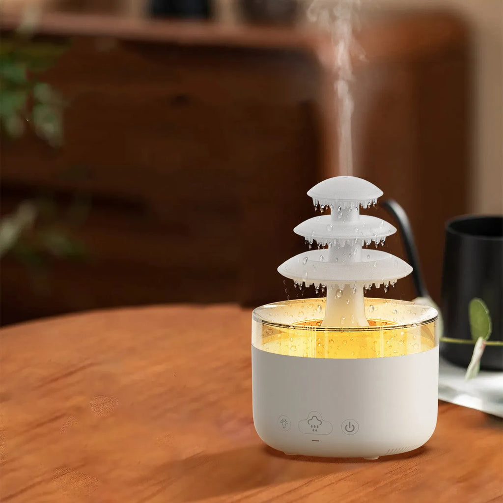 White cloud rain ultrasonic humidifier and essential oil diffuser with colourful LED lights on desk