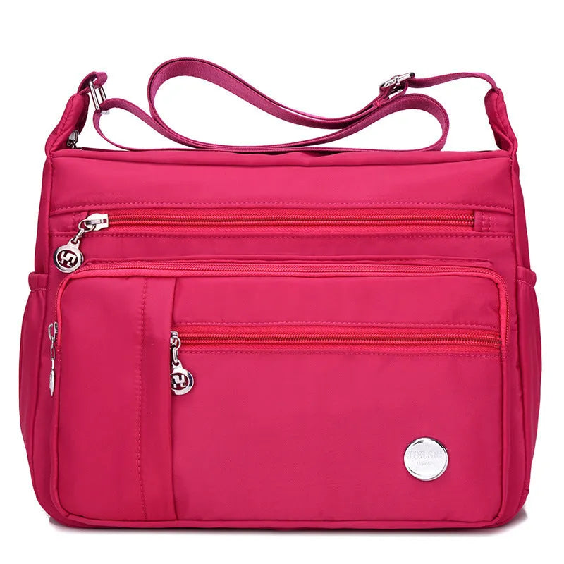 Lightweight nylon women's one shoulder crossbody bag in black with horizontal square shape and visible sewing thread detail