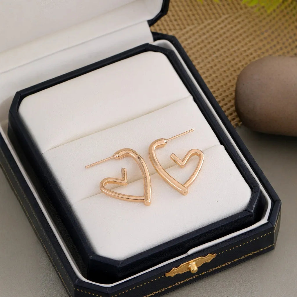 Golden love earrings for women with a simple cold style heart design