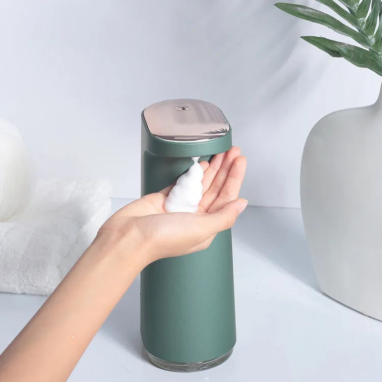 White automatic foam soap dispenser with infrared sensor for touch-free operation on a bathroom counter.