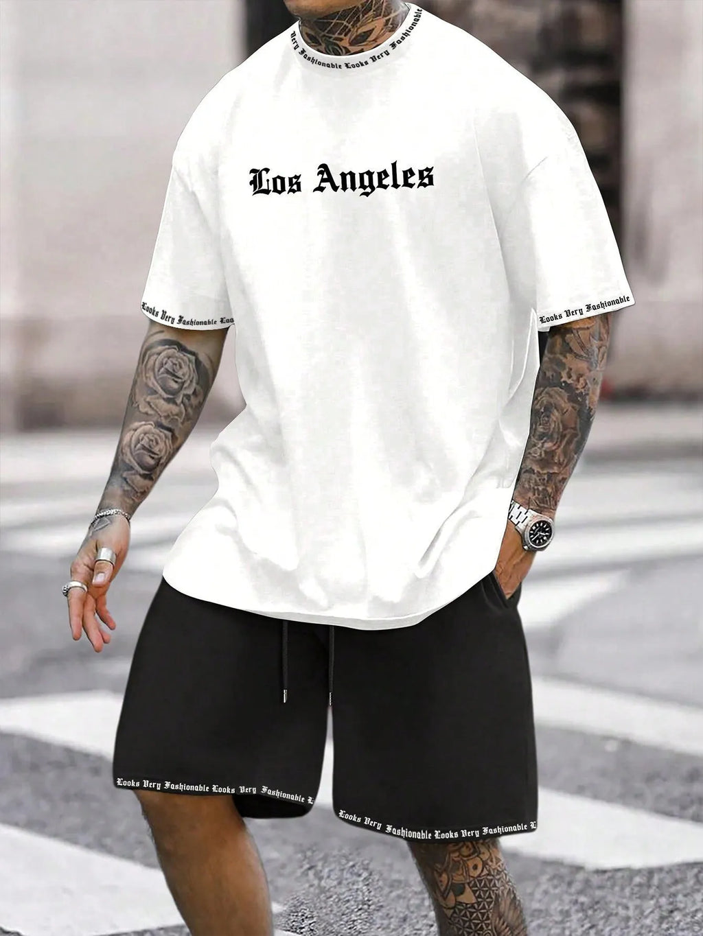 Man wearing a grey short-sleeved sports top and matching shorts from a quick-dry two-piece set.