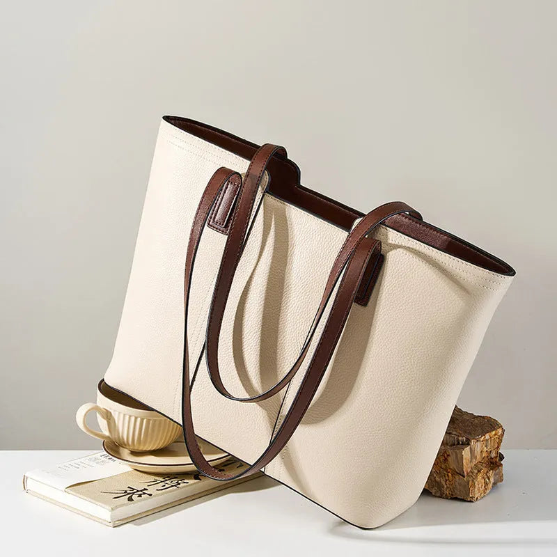 Women's black cowhide leather crossbody bag showing multiple internal compartments including phone pocket and file storage