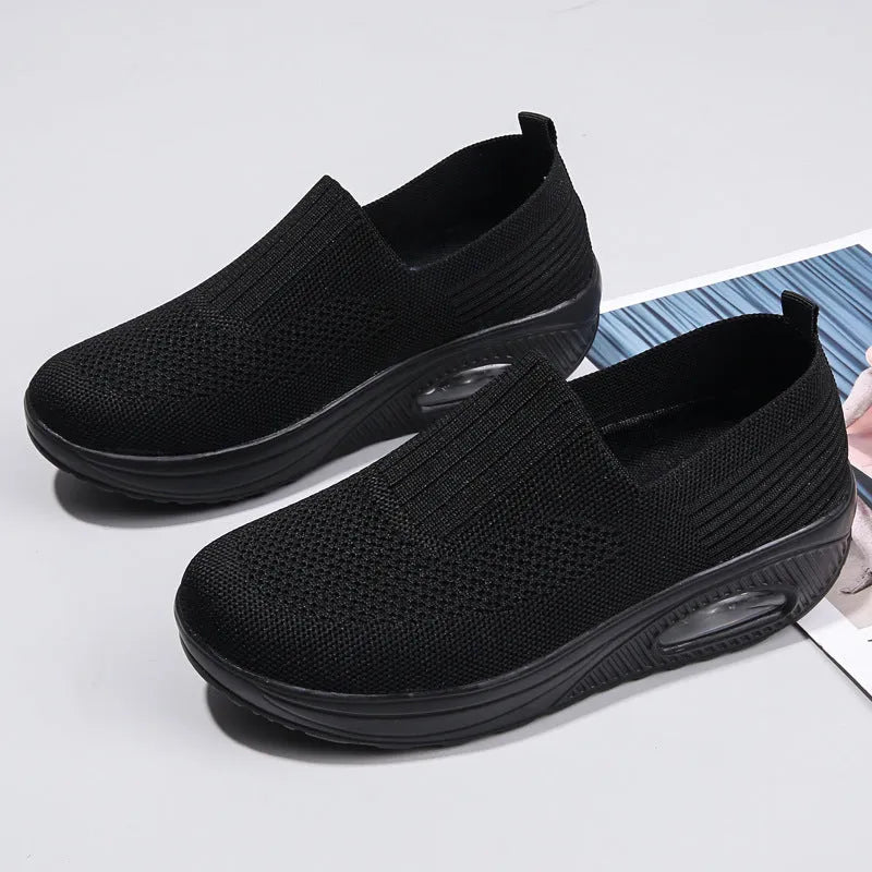 Women's casual running shoes with mesh and PU upper in beige, showing round toe and mid-heel design.