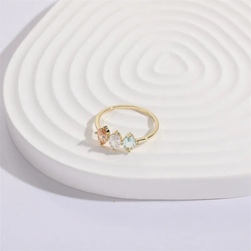 Mother's Day birthstone ring with geometric triangle design and horse eye tricolour zircon stones in 14k gold colour