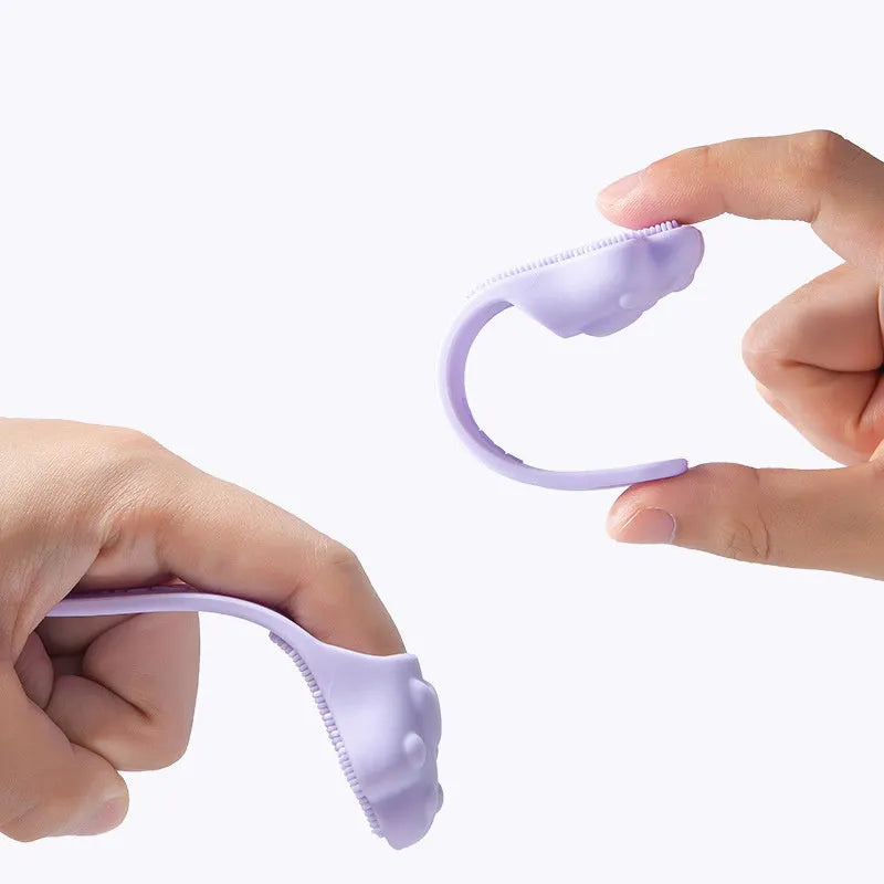 Pink silicone finger cover toothbrush for pets on a white background