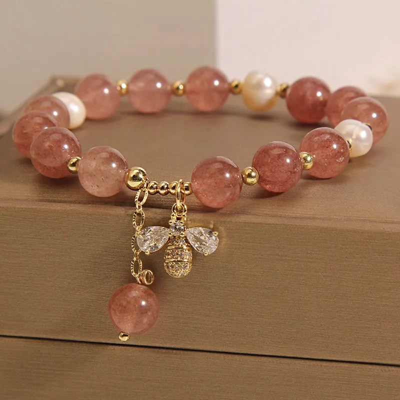 Women's bracelet with strawberry quartz stones, freshwater pearls, and zircon on an alloy chain.