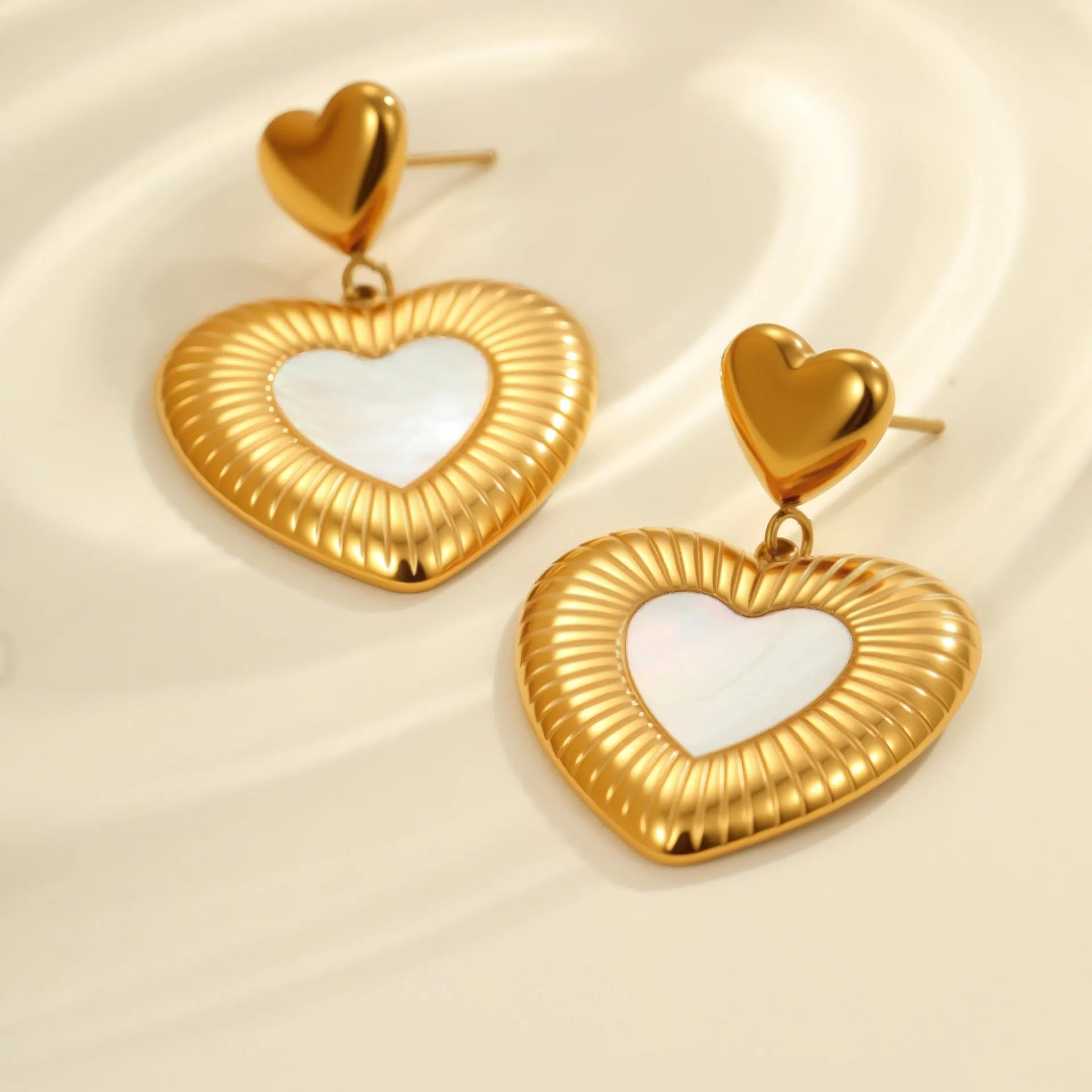 Gold electroplated heart-shaped stainless steel earrings with white fritillary detail