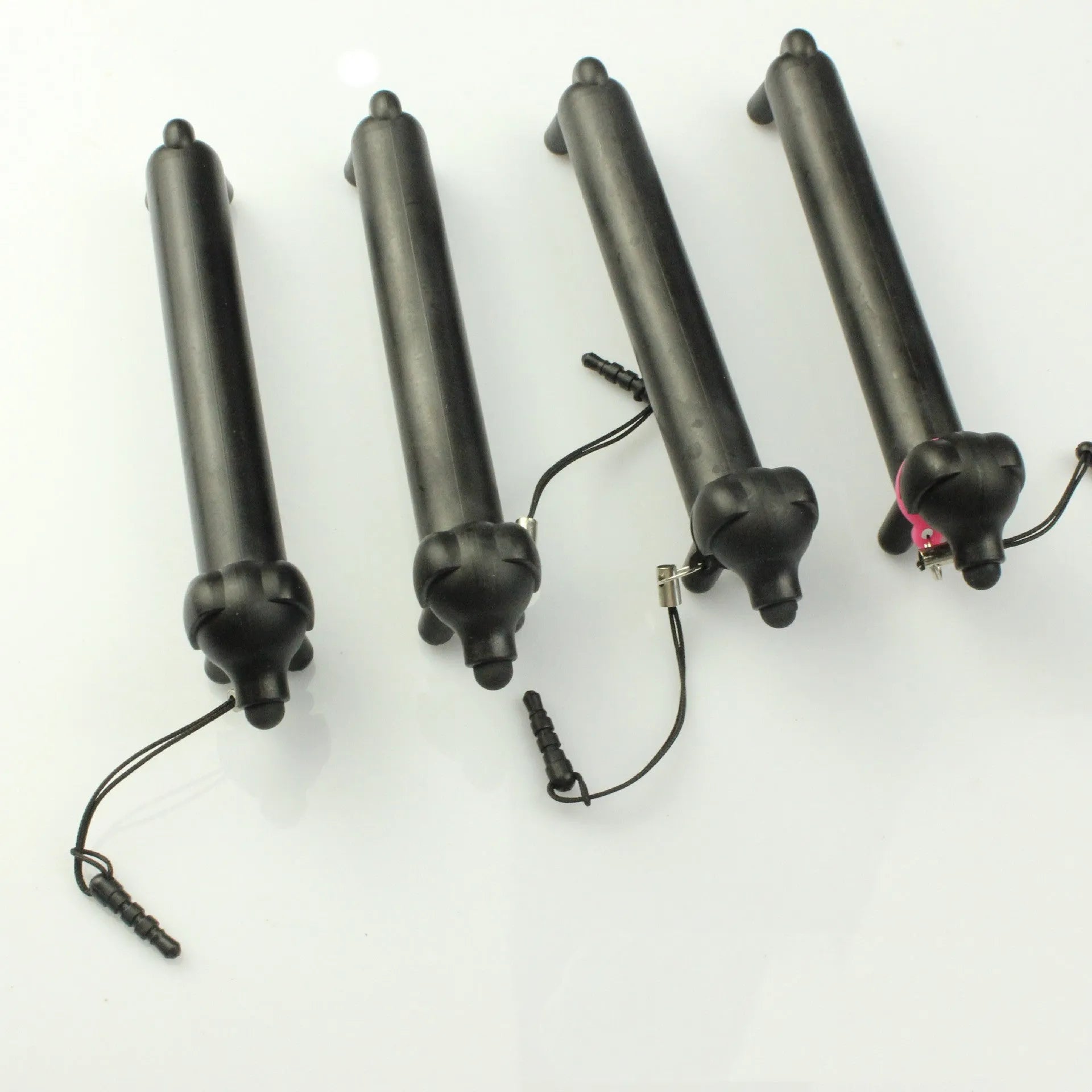 Black dog-shaped touch screen stylus shown with phone holder configuration