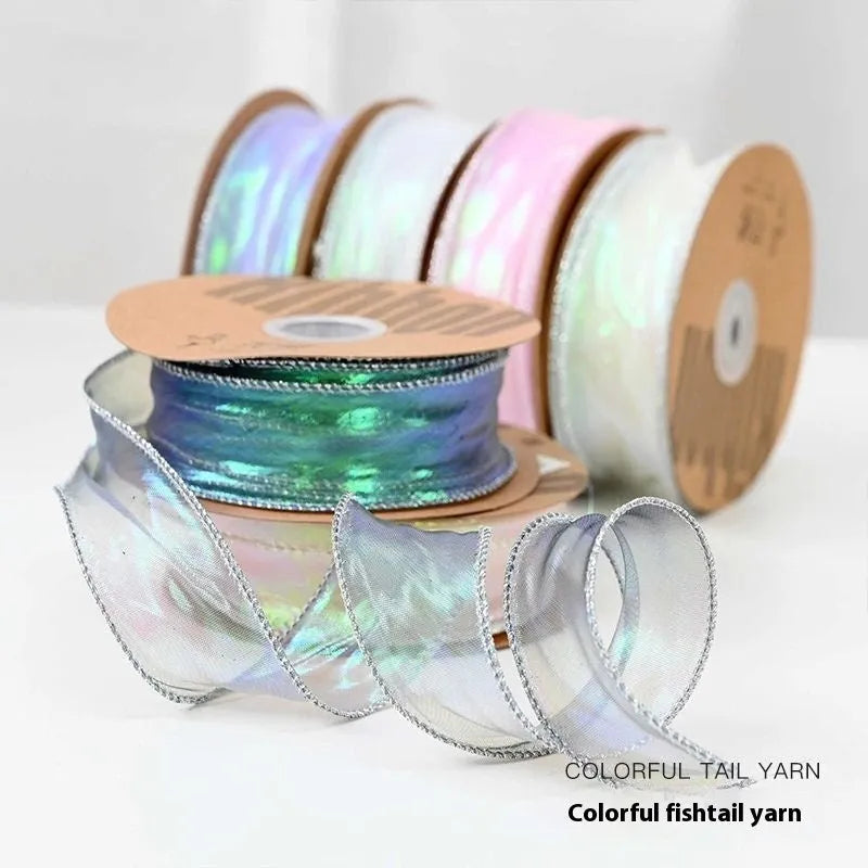Roll of colourful wave fishtail yarn ribbon in illusion champagne colour, showing textured pattern and 4cm width.