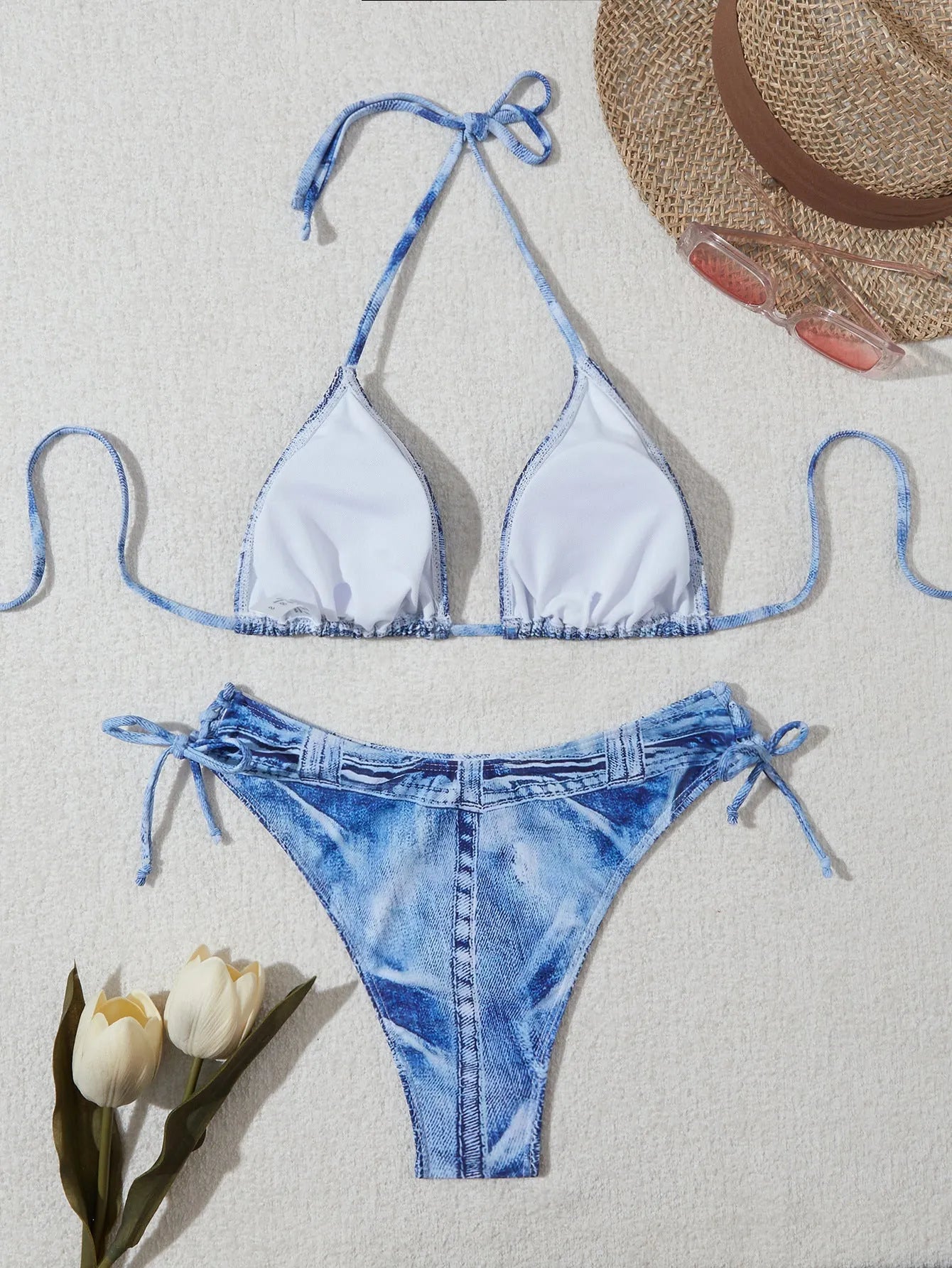 Women's denim blue printed bikini set with adjustable straps on a mannequin.