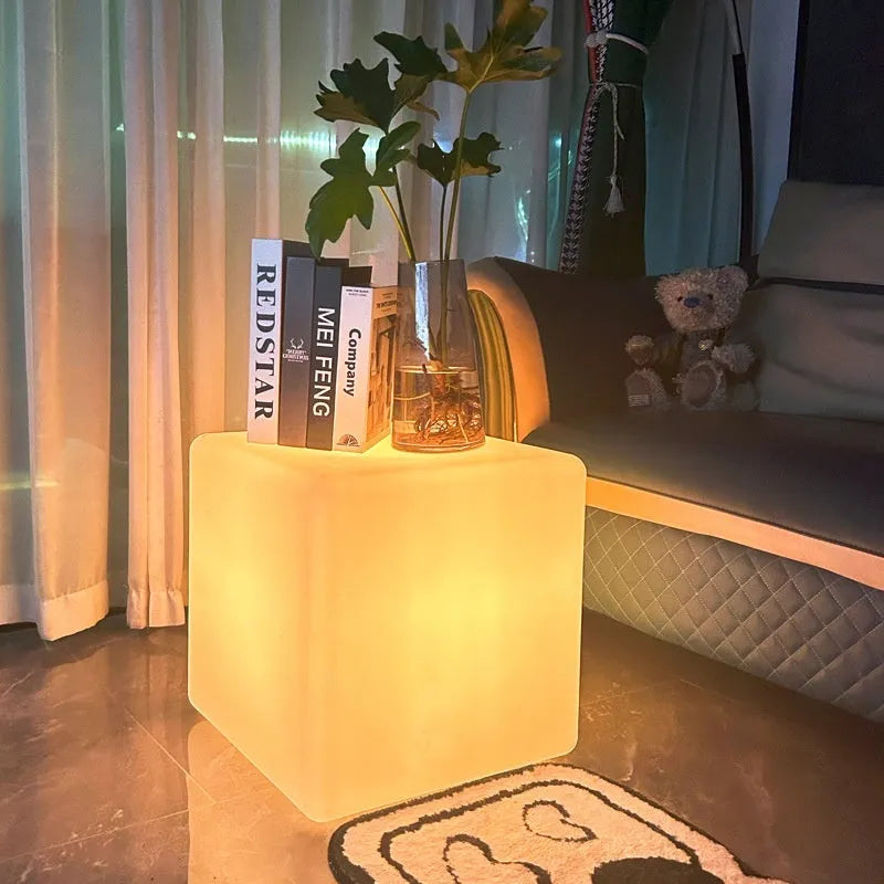White square LED cube light stool on grass, showing modern design and waterproof build for outdoor use.