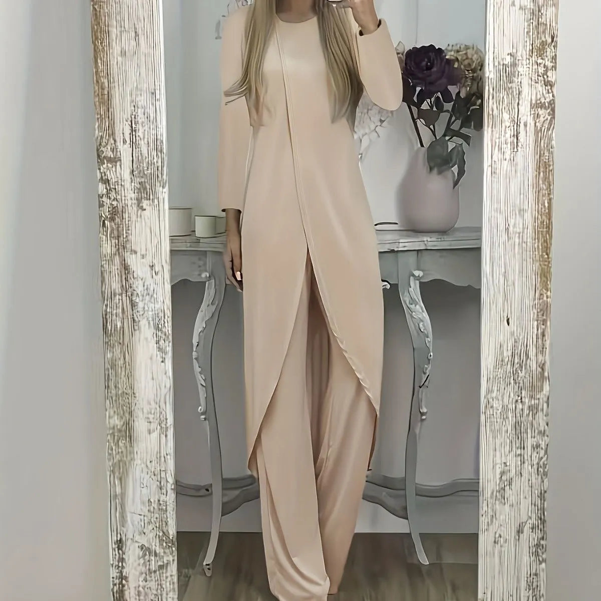 Casual long sleeve two-piece loungewear set in a neutral colour, showing the loose round neck top and matching trousers.