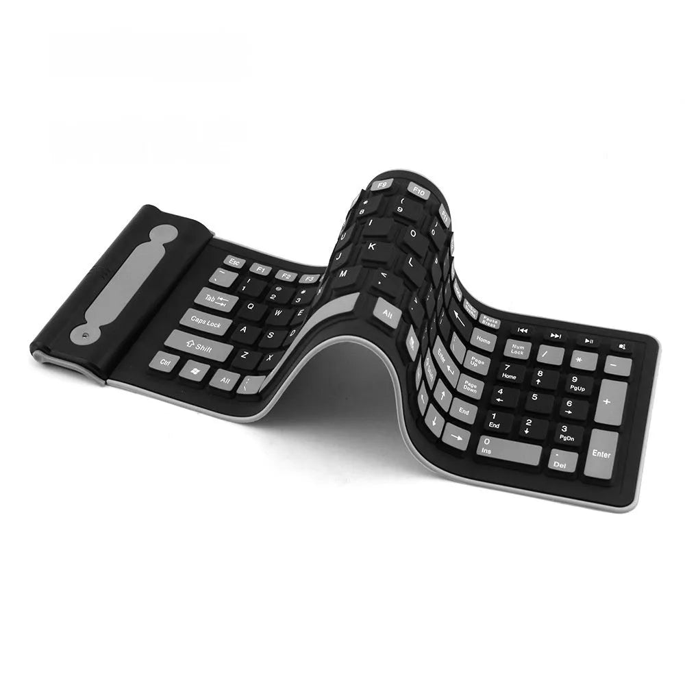 24g wireless mute folding silicone keyboard in folded position on a desk, showing USB receiver