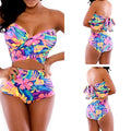 Red printed two-piece swimsuit with chest wrap top and matching pants.