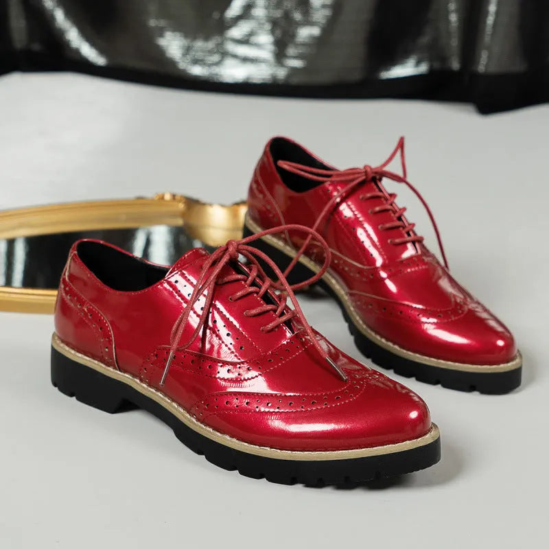 Women's black lace-up Oxford loafers with a wedge heel and sequin detail on the upper.