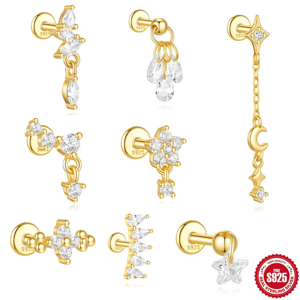 S925 sterling silver moon and star earrings with diamond accents on a gold-coloured background.