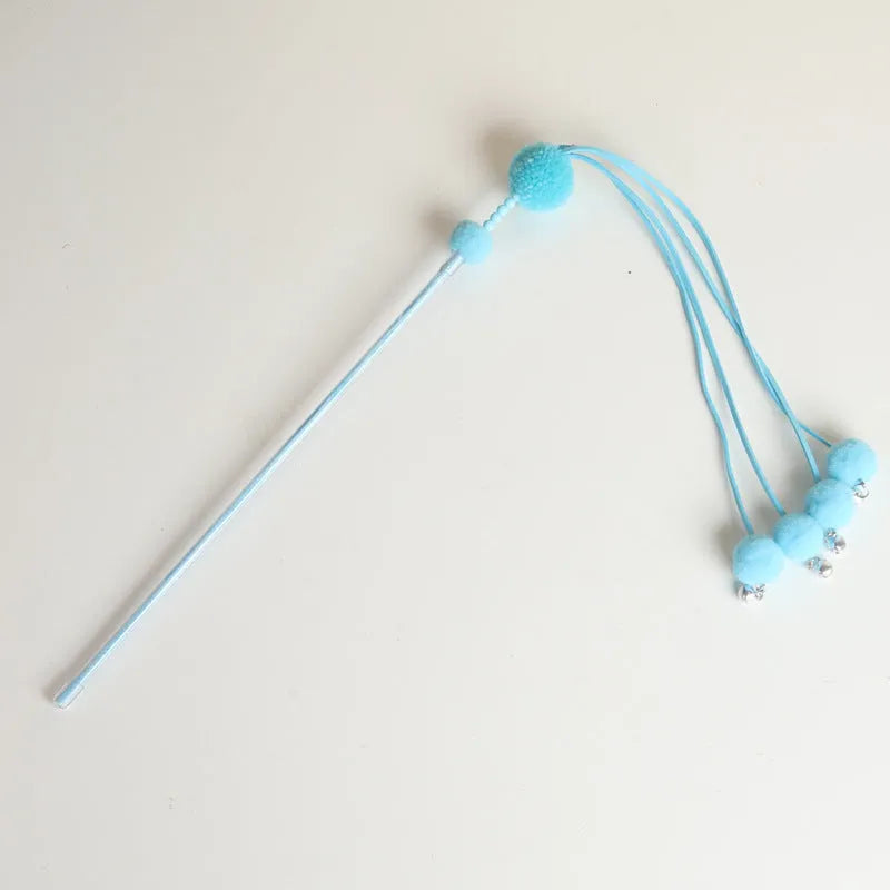Blue cat toy wand with a fluffy tassel on a stick for interactive pet play.