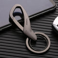 Black zinc alloy rectangular key chain with a carabiner clip and double ring, shown next to a set of keys for scale.