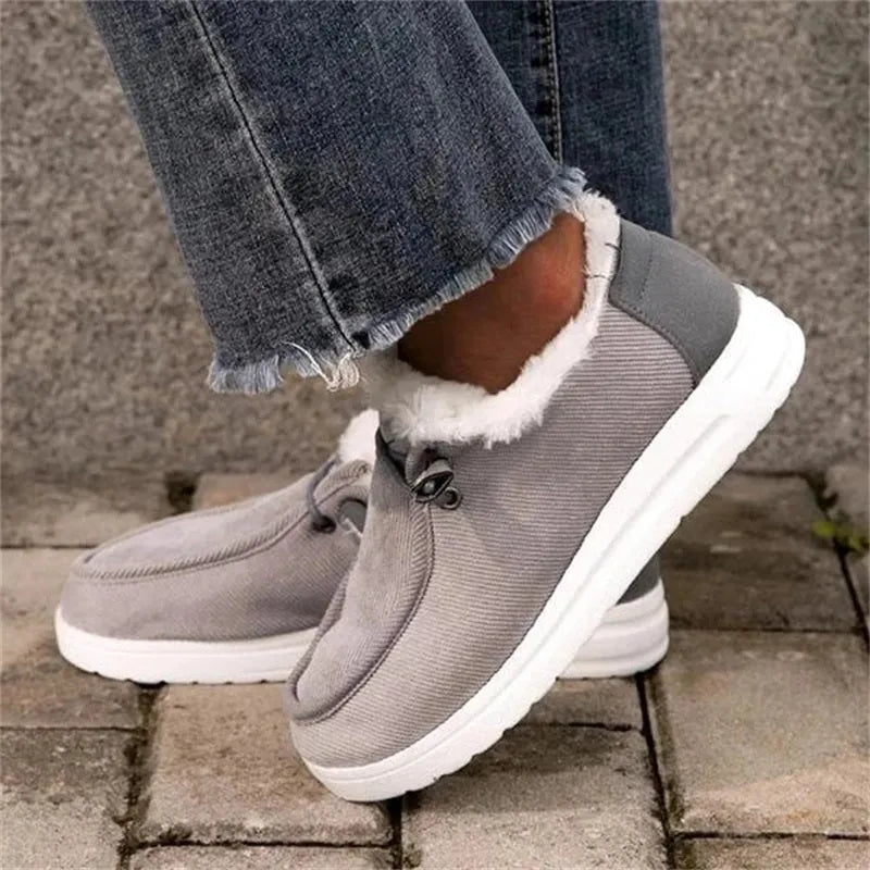 Women's winter snow boots with cotton upper and plush lining in grey, side view showing front-tie lacing and ankle height