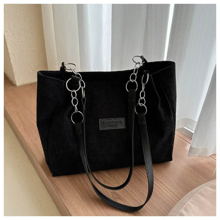 Corduroy one-shoulder tote handbag in a horizontal square shape, shown in black, brown, or white.
